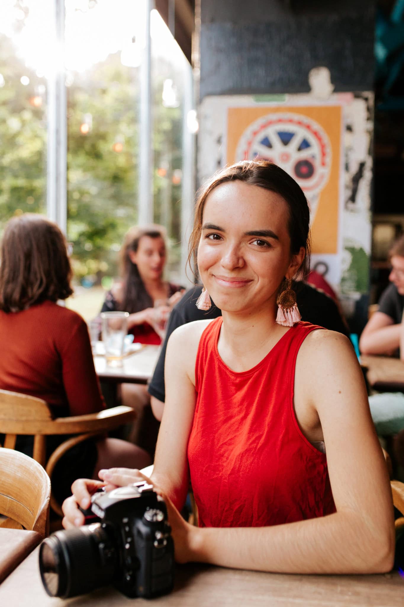 Photographie portrait de Mirona, photographe d'évènements à Montréal. On la voit souriant avec une caméra à la main.