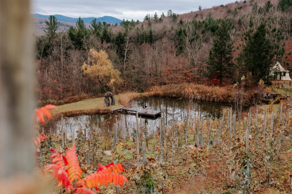 Aerial view of the heart-shaped lake and dock at Château Sainte-Agnès in Sutton, surrounded by vineyards and fall foliage — Eastern Townships proposal location